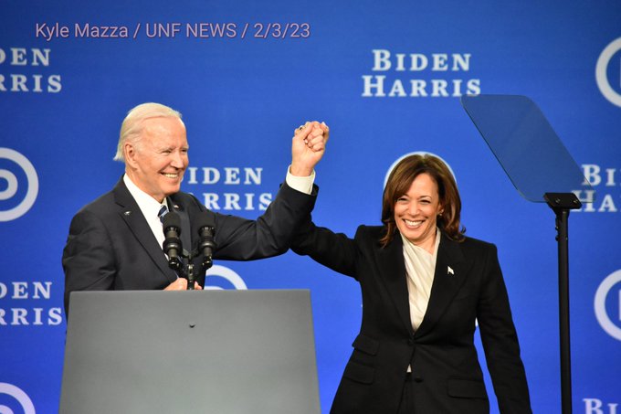 President of the United States Joe Biden and Vice President of the United States Kamala Harris embrace and join hands on stage at the DNC Winter Meeting in Philadelphia, Pennsylvania on February 3, 2023